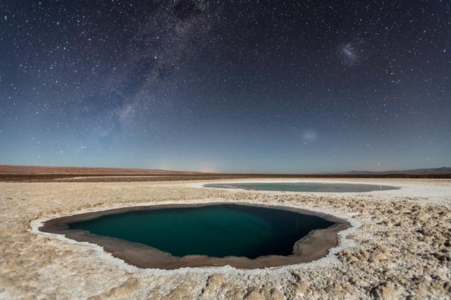 The Baltinache Ponds, also called Hidden Ponds are a set of seven salt ponds located in the area of the Salt Cordillera, near San Pedro de Atacama, in the second region of northern Chile, in the Atacama desert. After much research, I believe to be the first photographer to publish night photos of this place, but it is still necessary to confirm this information. Tech Details: Photography done in one shot. Foreground was illuminated by the moonlight. Reduced exposure in Lightroom in +/- 1EV. 2016 National Geographic Travel Photographer of the Year WINNERS