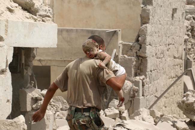 EDITORS NOTE: Graphic content / A Syrian man carries a wounded baby in the rubble of buildings following a barrel bomb attack on the Bab al-Nairab neighbourhood of the northern Syrian city of Aleppo on August 25, 2016. / AFP PHOTO / AMEER ALHALBIAMEER ALHALBI/AFP/Getty Images
