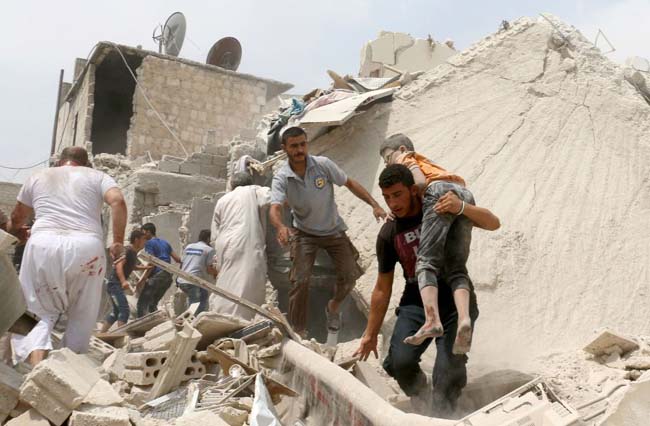 A Syrian man carries a wounded child following a barrel bomb attack on the Bab al-Nairab neighbourhood of the northern Syrian city of Aleppo on August 25, 2016. / AFP PHOTO / AMEER ALHALBIAMEER ALHALBI/AFP/Getty Images