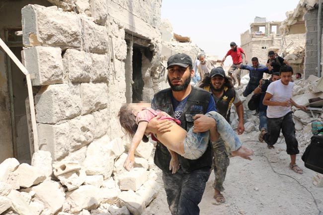 Pixellated version A Syrian man carries a wounded child following a barrel bomb attack on the Bab al-Nairab neighbourhood of the northern Syrian city of Aleppo on August 25, 2016. / AFP PHOTO / AMEER ALHALBIAMEER ALHALBI/AFP/Getty Images