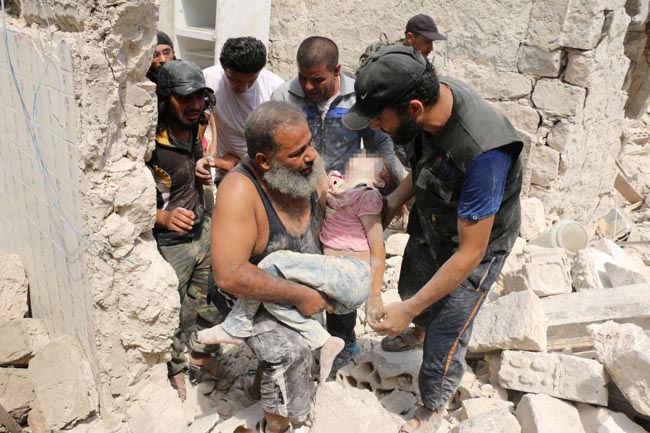 PIXELLATED VERSIONS EDITORS NOTE: Graphic content / A wounded Syrian man sits in the back of a truck next to a dead girl following a barrel bomb attack on the Bab al-Nairab neighbourhood of the northern Syrian city of Aleppo on August 25, 2016. / AFP PHOTO / AMEER ALHALBIAMEER ALHALBI/AFP/Getty