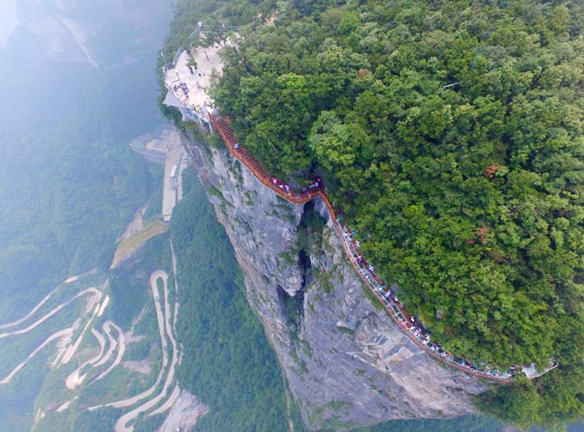 Mandatory Credit: Photo by Imaginechina/REX/Shutterstock (5813021h) Aerial view of the 100-meter-long and 1.6-meter-wide glass skywalk overlooking the "Tianmen Tongtian Avenue" on the cliff of Tianmen Mountain Glass skywalk opens on Tianmen Mountain, Hunan province, China - 01 Aug 2016 A 100-meter-long and 1.6-meter-wide glass skywalk in Zhangjiajie Tianmenshan National Park opened to visitors on Monday (1 August 2016). The Coiling Dragon Cliff skywalk is the third glass skywalk on the Tianmen Mountain (or Tianmenshan Mountain) in Zhangjiajie National Forest Park in central China's Henan province. It oversees the "Tianmen Tongtian Avenue" (Avenue toward Heav