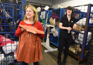 Linda Hoffman of Placentia, left, holds on to a shirt she donated to Goodwill last Tuesday, not knowing her husband left an envelope with $8000 in the shirt pocket. The shirt was found by Goodwill processing associate Caitlin Mulvihill, right. Hoffman's husband was secretly saving money in hopes of taking her on a surprise trip to Italy. Monday, February 13, 2017. (Photo by Nick Agro, Orange County Register/SCNG)