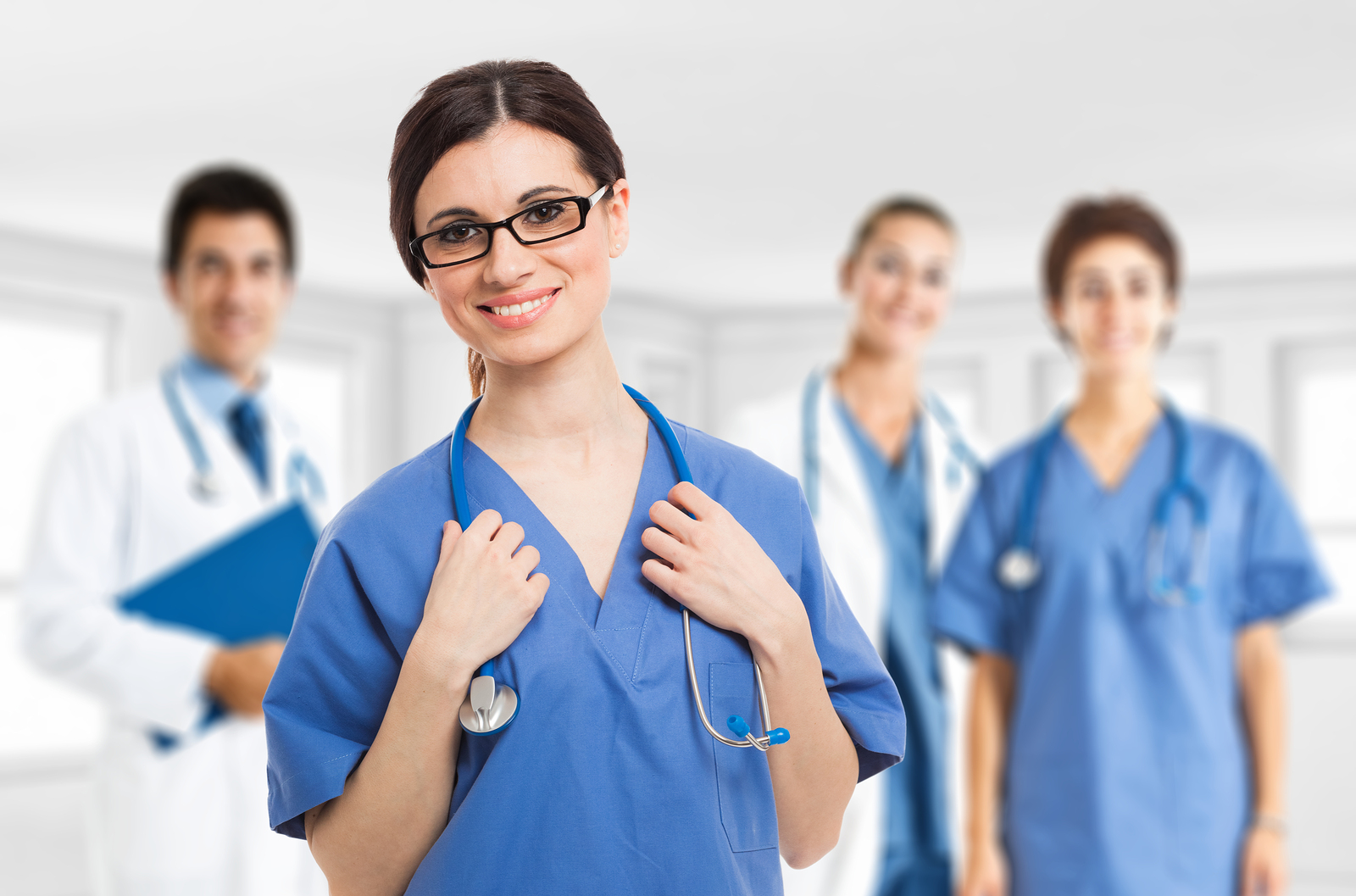 Portrait of a smiling nurse in front of her medical team