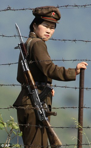 3FBCFC0900000578-4458844-A_female_North_Korean_soldier_looks_out_from_behind_a_barded_wir-a-10_1493488537448